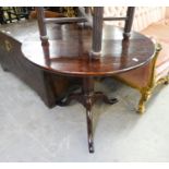 AN ANTIQUE OAK CIRCULAR TILT TOP SMALL TABLE, RAISED ON TRIPOD BASE