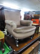 A VICTORIAN ALL-UPHOLSTERED LOUNGE CHAIR, COVERED IN LIGHT BROWN VELVET, ON MAHOGANY TURNED FRONT