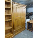 A GOOD QUALITY PINE DOUBLE WARDROBE, WITH TWO PANEL DOORS ABOVE TWO DRAWERS, 194cm high x 122cm wide