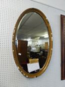 OVAL BEVEL EDGED WALL MIRROR IN MOULDED GILT FRAME, 33" X 20", LOSSES TO THE MOULDING