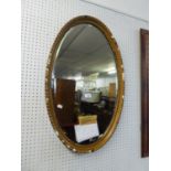 OVAL BEVEL EDGED WALL MIRROR IN MOULDED GILT FRAME, 33" X 20", LOSSES TO THE MOULDING