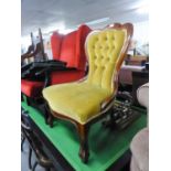 A VICTORIAN STYLE MAHOGANY FRAMED NURSING CHAIR WITH GOLD BUTTON BACK FABRIC