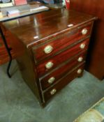 A MAHOGANY SMALL CHEST OF FOUR GRADUATED LONG DRAWERS, THE BRASS DROP HANDLES WITH EMBOSSED OVAL