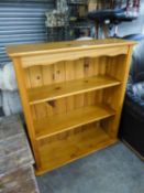 GOOD QUALITY PINE OPEN BOOKCASE, HAVING TWO SHELVES ON BUN FEET