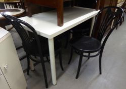 A WHITE FINISH OBLONG KITCHEN TABLE ON METAL POST SUPPORTS, 4' X 2' AND A SET OF FOUR BLACK FINISH