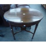 AN OVAL INLAID MAHOGANY OCCASIONAL TABLE WITH 'X' UNDERTIER