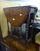 AN OAK DROP-LEAF OCCASIONAL TABLE RAISED ON SPIRAL LEGS