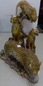 LARGE PAINTED RESIN FIGURE OF A LEOPARD ON A SNARLED TREE STUMP, 16" (40.6cm) high, SIMILAR FIGURE