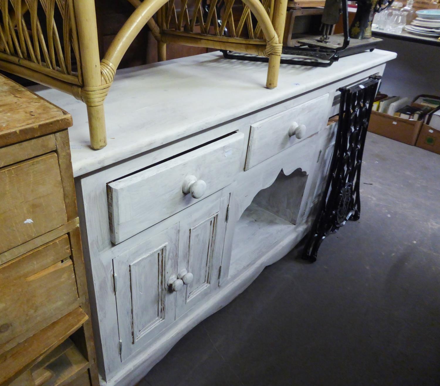 A WHITE PAINTED DRESSER WITH A ROW OF THREE SHORT FRIEZE DRAWERS OVER A CENTRE OPEN COMPARTMENT,