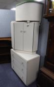 A WHITE LOOM OTTOMAN BOX WITH UPHOLSTERED LID; A MELAMINE CORNER BEDSIDE CUPBOARD AND A WHITE