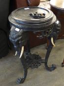 INDIAN EBONISED JARDINIÈRE STAND, with three elephant mask and trunk supports, (a/f), 28 ½? high