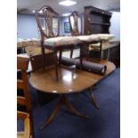 A REPRODUCTION MAHOGANY TWIN PEDESTAL DINING TABLE WITH EXTRA LEAF AND A PAIR OF MAHOGANY DINING