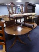 A REPRODUCTION MAHOGANY TWIN PEDESTAL DINING TABLE WITH EXTRA LEAF AND A PAIR OF MAHOGANY DINING