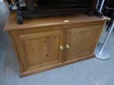 A LOW TWO DOOR PINE CUPBOARD