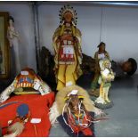 A RESIN STANDING FIGURE OF A COWBOY HOLDING A RIFLE, 20? HIGH (A.F.), TWO NATIVE AMERICAN WALL MASKS