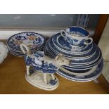 EIGHT POTTERY WILLOW PATTERN PLATES; TWO MEAT PLATES AND A TWO HANDLED SOUP CUP; WILLOW PATTERN