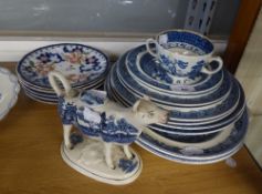 EIGHT POTTERY WILLOW PATTERN PLATES; TWO MEAT PLATES AND A TWO HANDLED SOUP CUP; WILLOW PATTERN