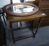 AN OAK OBLONG OCCASIONAL TABLE, RAISED ON SPIRAL LEGS AND A SMALL OAK FRAMED OVAL WALL MIRROR (2)