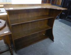 AN OAK OPEN BOOKCASE WITH SHAPED TOP