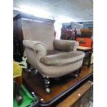 A VICTORIAN ALL-UPHOLSTERED LOUNGE CHAIR, COVERED IN LIGHT BROWN VELVET, ON MAHOGANY TURNED FRONT