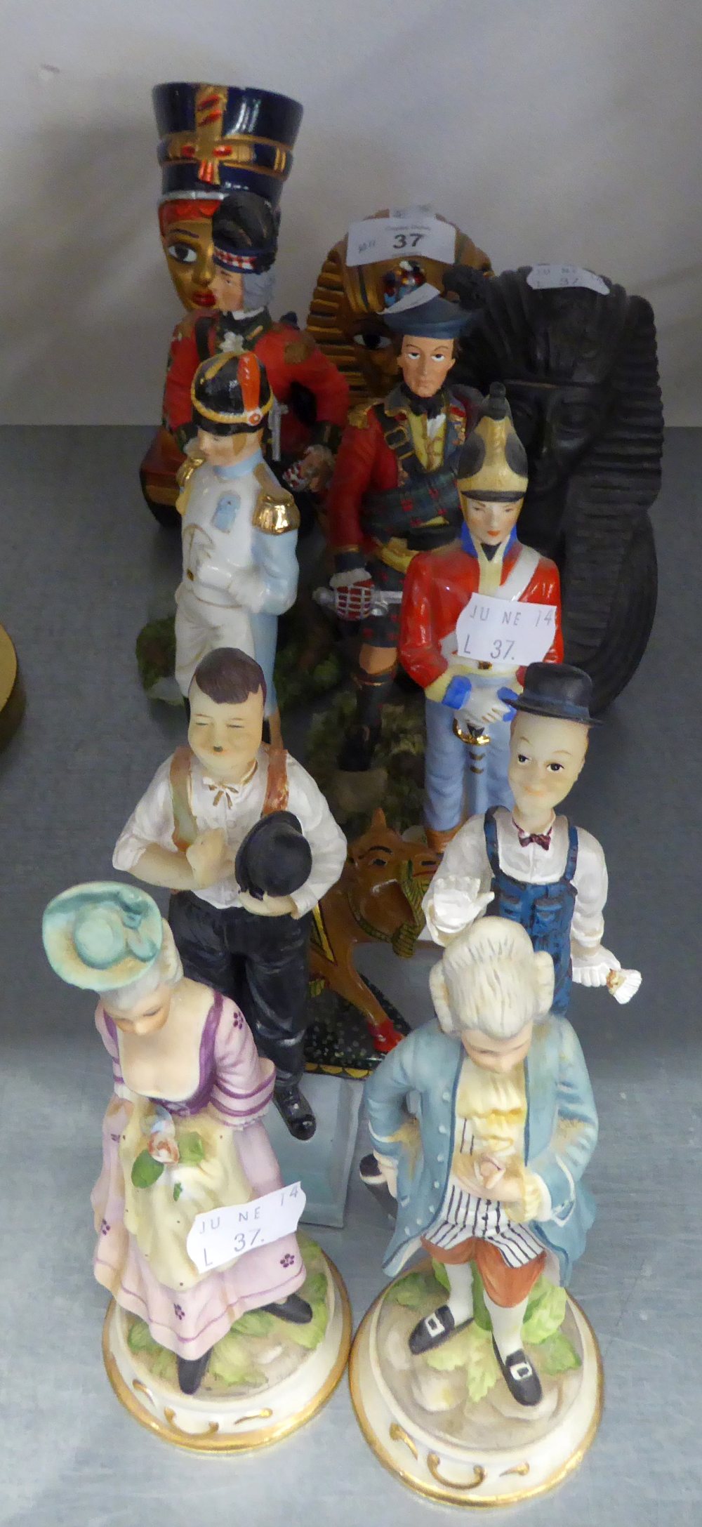 A PAIR OF CHINA FIGURES, SOLDIERS; A PAIR OF BISQUE FIGURES, COURTIER AND LADY; TWO PAIRS OF RESIN