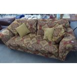 A LARGE 'DURESTA' THREE SEATER SETTEE COVERED IN RED AND CREAM FABRIC