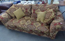 A LARGE 'DURESTA' THREE SEATER SETTEE COVERED IN RED AND CREAM FABRIC