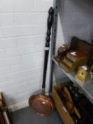 AN ANTIQUE COPPER BED WARMING PAN WITH LONG TURNED WOOD HANDLE