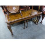 A LONG, FIGURED WALNUT WOOD COFFEE TABLE, WITH L.P.G.P. CARVED EDGES AND THE PAIR OF NESTING