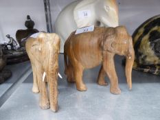 TWO CARVED SOFT WOOD MODELS OF ELEPHANTS WITH TUSKS, 4 1/2in (11.4cm) AND 3 1/2in (8.8cm) HIGH (2)