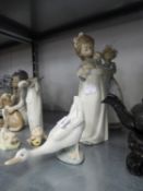 TWO NAO SPANISH PORCELAIN FIGURES OF GIRLS, ONE HOLDING A PUPPY, THE OTHER HOLDING A DOLL AND A