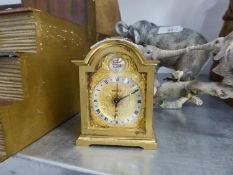 SWIZA SMALL SPRING-DRIVEN GILT BRASS MANTEL CLOCK, WITH CARRYING HANDLE