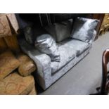 A DOUBLE SOFA BED COVERED IN SILVER CRUSHED VELVET