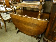 AN OAK OVAL GATE LEG DINING TABLE, ON TWO TRESTLE SUPPORTS WITH SLEDGE FEET, THE PLAIN GATE LEGS