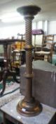 A BEECHWOOD PLANT STAND/TORCHERE HAVING SPIRAL COLUMN AND A CIRCULAR RUG (2)