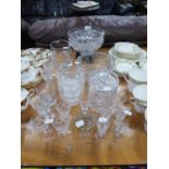 CUT GLASS LARGE FRUIT DISH ON BLACK STAND, ANOTHER CUT GLASS FRUIT BOWL, WATER JUG, JAR AND COVER