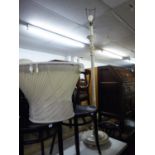 A WHITE PAINTED STANDARD LAMP WITH FRILLY SILK SHADE