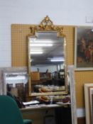 A GILT PIER MIRROR, WITH STEPPED TOP WITH ORNATE FOLIATE OPEN SCROLL PEDIMENT, THE FRAME WITH MIRROR