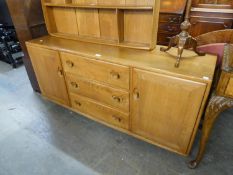 A RETRO 1960's ERCOL WINDSOR SIDEBOARD, HAVING THREE CENTRAL DRAWERS, FLANKED BY TWO END CUPBOARDS