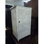 A WHITE LOOM BEDSIDE CUPBOARD WITH PLATE GLASS PROTECTOR