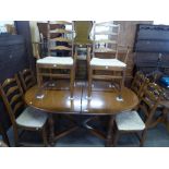 AN ERCOL D-END EXTENDING DINING TABLE WITH FOLD-AWAY LEAF AND SIX MATCHING DINING CHAIRS (4 + 2)