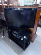 LG FLAT SCREEN TELEVISION ON BLACK GLASS THREE TIER STAND, WITH SKY BOX; TOSHIBA VIDEO AND LG BLU-