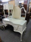 A WHITE FINISH, SERPENTINE, KNEEHOLE DRESSING TABLE WITH TRIPLE MIRRORS; A PAIR OF MATCHING