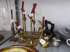 SET OF 7 BRASS GRADUATED CANDLESTICKS WITH SLENDER COLUMNS AND DISHED CIRCULAR BASES; TWO BRASS SWAN