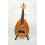 MODERN, UNBRANDED OUD, with foliate pierced sound holes and faux tortoiseshell pick guard to the