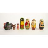 THREE RUSSIAN DECORATED WOOD NESTING FIGURES/DOLLS, depicting girl in costume, comic cat character