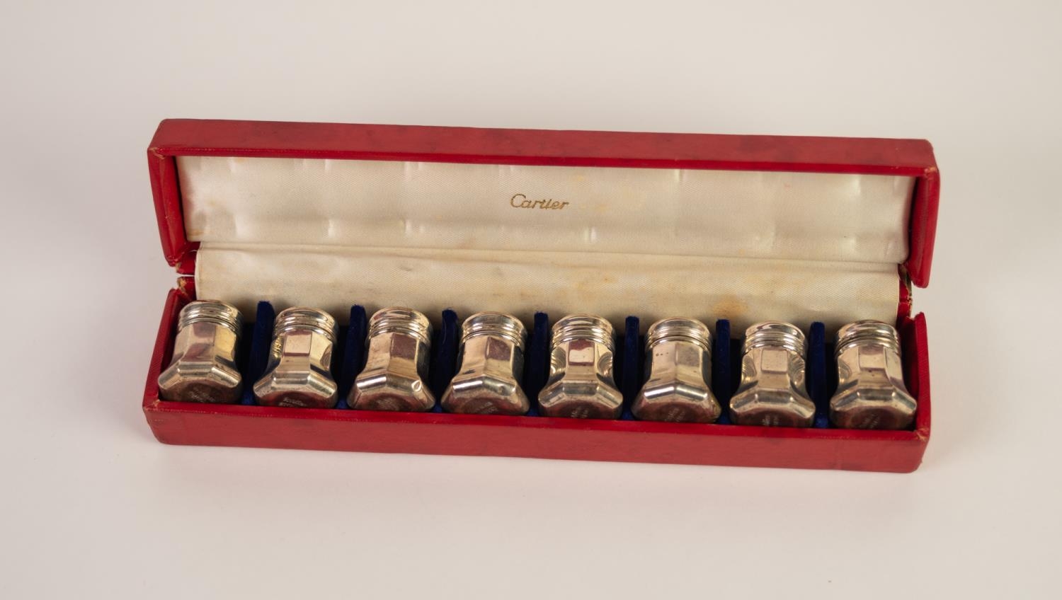 SET OF EIGHT CARTIER SMALL STERLING SILVER PEPPERETTES, of octagonal form with screw tops, bases