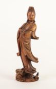 MID TWENTIETH CENTURY CHINESE CARVED BOXWOOD FIGURE OF GUANYIN foot raised on head of an animal with