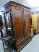 A LARGE MAHOGANY WARDROBE WITH TWO LARGE PANEL DOORS OVER LONG SINGLE DRAWER, RAISED ON PLINTH BASE