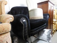 A BLACK VELVET TWO SEATER SETTEE (NEARLY NEW)